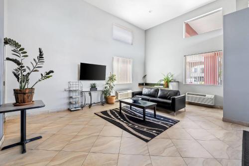 a living room with a couch and a tv at Super 8 by Wyndham Marana/Tucson Area in Tucson