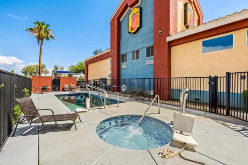 a patio with a hot tub in front of a building at Super 8 by Wyndham Marana/Tucson Area in Tucson