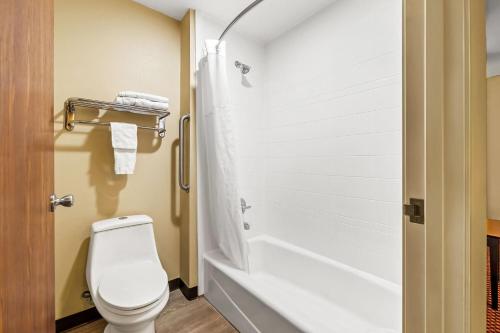 a bathroom with a white toilet and a shower at Super 8 by Wyndham Marana/Tucson Area in Tucson
