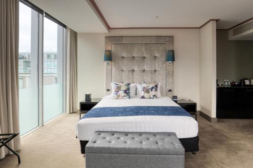a bedroom with a large bed and a large window at Marsden Viaduct in Auckland