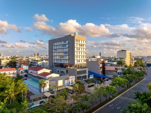 a tall building with a clock on the top of it at Tru by Hilton Can Tho Cai Khe in Can Tho