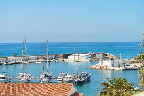 a group of boats docked in a harbor at Estela Barcelona in Sitges