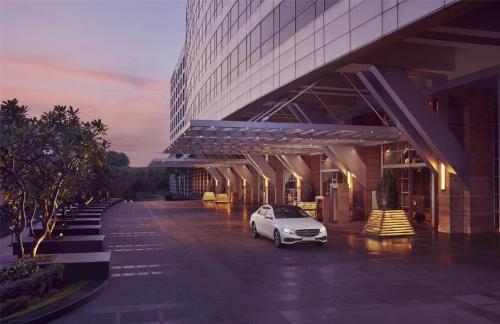 a car parked in a parking lot in front of a building at Grand Hyatt Mumbai Hotel and Residences in Mumbai