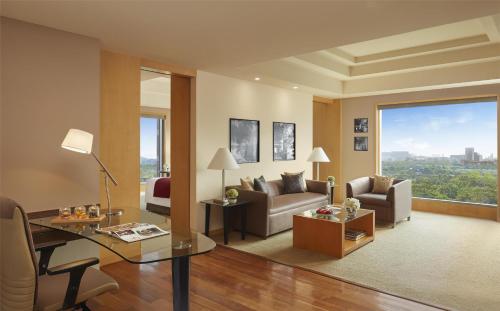 a living room with a couch and a table at Grand Hyatt Mumbai Hotel and Residences in Mumbai