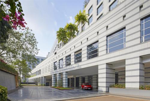 a red car parked in front of a building at Grand Hyatt Mumbai Hotel and Residences in Mumbai