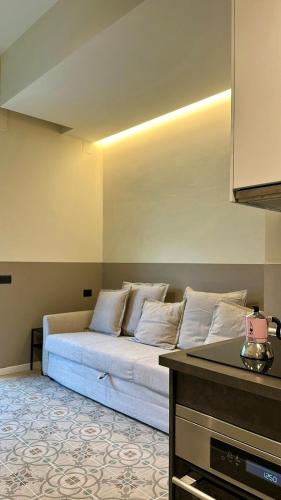 a living room with a bed in the corner of a room at Residenza Duca degli Abruzzi in Pescara