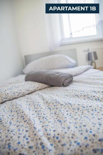 a bed with a blanket on top of it at Słoneczne Wzgórze Zator in Zator