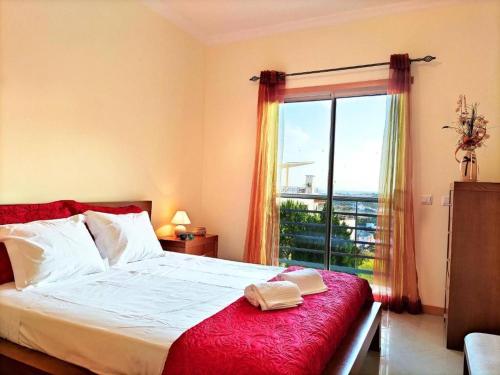 a bedroom with a bed and a large window at AlbufeiraOrada BlueSky by Be Cherish in Albufeira