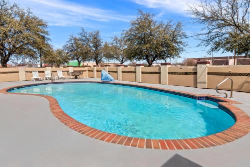 a large swimming pool with blue water at Quality Inn & Suites - Granbury in Granbury