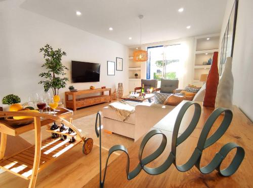 a living room with a large sign that says uconn at Luxury Townhouse in Top Complex with Town and Ocean View by Be Cherish in Albufeira