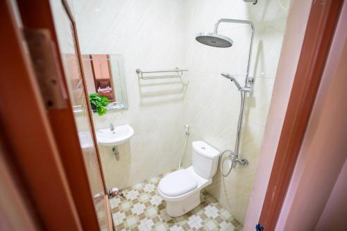 a bathroom with a toilet and a sink at Joglo Prambanan A4 in Bugisan