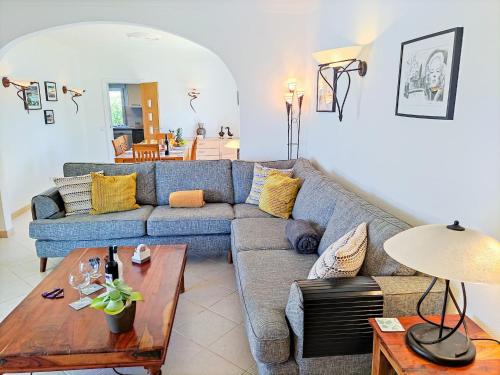a living room with a blue couch and a table at Stunning Casa Nicole by Be Cherish in Pêra