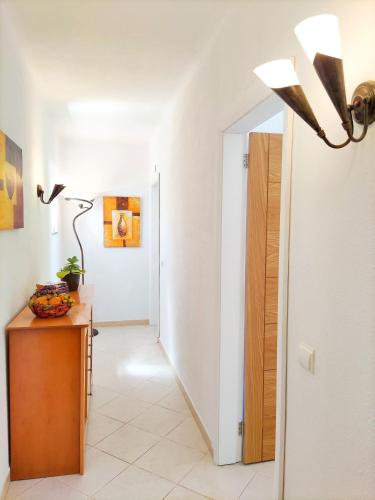 a hallway with a table and a lamp and a door at Stunning Casa Nicole by Be Cherish in Pêra