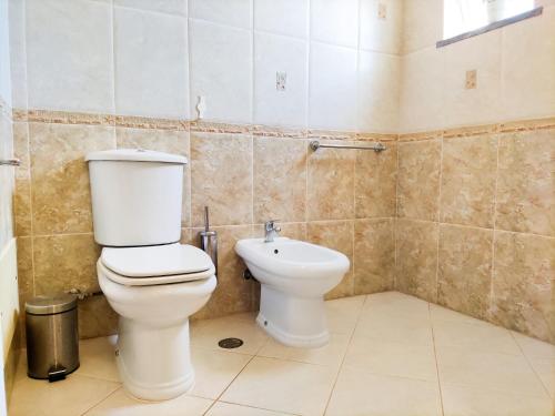 a bathroom with a toilet and a sink at Stunning Casa Nicole by Be Cherish in Pêra