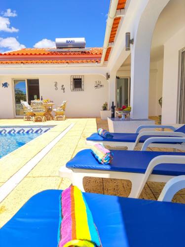 a pool with chaise lounge chairs and a swimming pool at Stunning Casa Nicole by Be Cherish in Pêra