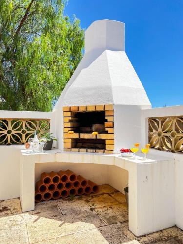 a pizza oven sitting on top of a patio at Stunning Casa Nicole by Be Cherish in Pêra