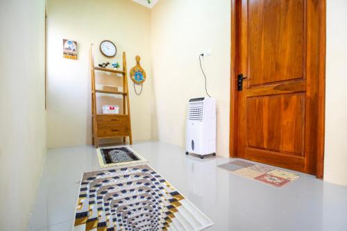 a room with a refrigerator and a door at Joglo Prambanan A4 in Bugisan