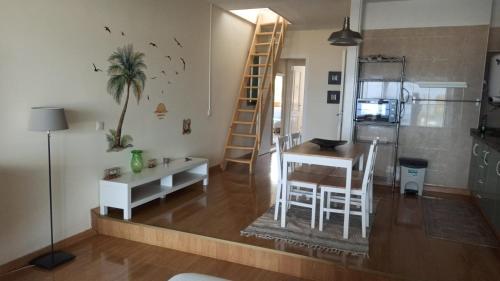 a living room with a dining room table and a kitchen at La Margarita villas canarias appartamento duplex in Adeje