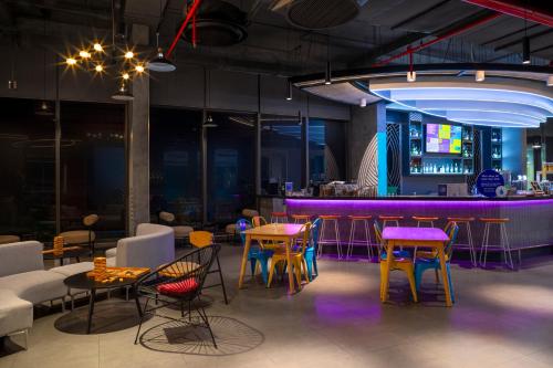 a room with tables and chairs and a bar at Tru by Hilton Can Tho Cai Khe in Can Tho