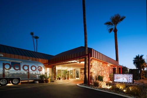 a truck parked in front of a building with palm trees at Papago Scottsdale by Reside, Trademark Collection by Wyndham in Scottsdale