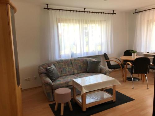 a living room with a couch and a table at Fewo Rotensol - Bad Herrenalb in Bad Herrenalb