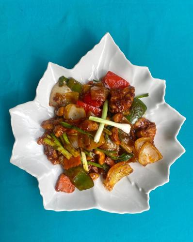 a white plate of food with meat and vegetables at Baan Kiao in Haad Yao