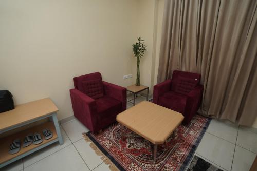 a living room with two chairs and a table at RIshikulam Wellness Centre in Samālkha