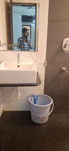 a man taking a picture of a bathroom sink at Calangute Square by Ananta in Calangute