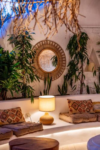 a living room with a couch and a mirror at Anthea Hotel in Tinos Town