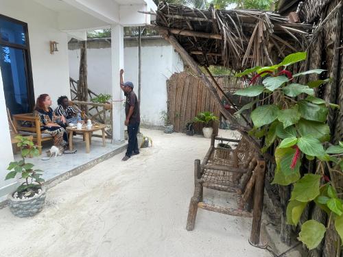 a man standing in the courtyard of a house at Zanzibar beach escape 1&2 in Bwejuu