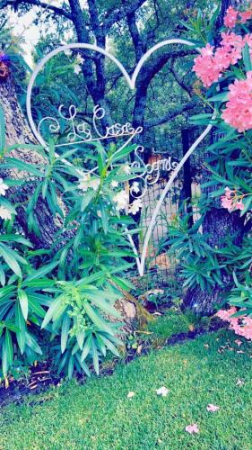 a garden with pink flowers and a metal fence at La Casa dei Sogni in Flayosc
