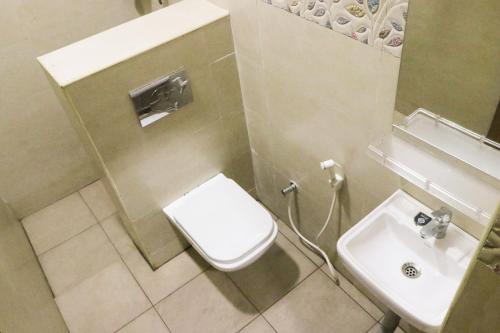a bathroom with a toilet and a sink at M3 Homestay in Madurai
