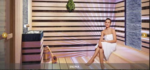 a woman in a white dress sitting in a room at Convinia Luxury The Peak Midtown -Free Airport Pick Up in Ho Chi Minh City