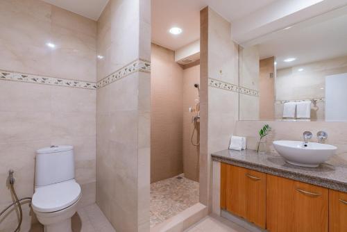 a bathroom with a toilet and a sink at Coral Cove Beachfront Villa - Koh Chang in Ko Chang