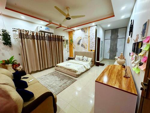 a living room with a bed and a table at AAA Guest House in Rawalpindi
