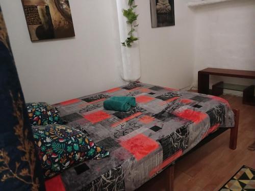 a bed with a quilt on it in a room at Villa des Filaos et du lagon o6, 93 , 70 , 59 , 79 in Saint-Leu