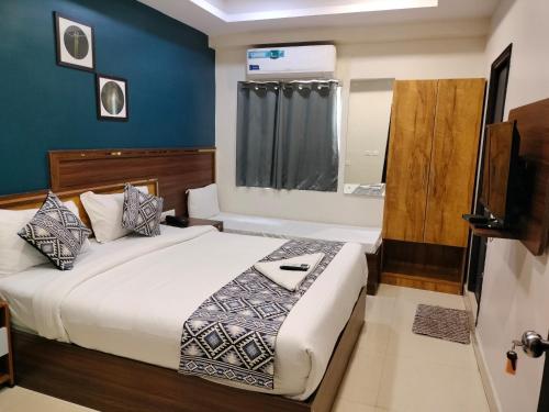 a hotel room with a bed and a television at Yellow Sapphire Hotel Hi-Tech City in Hyderabad