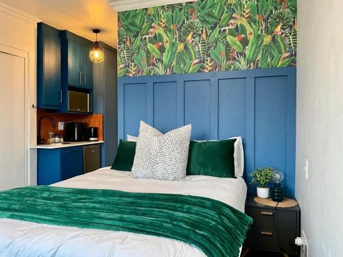a bedroom with a bed with a green blanket at Mountain Bay, 403 & 404, Strand in Strand