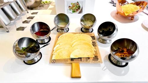 a group of bowls of food on a table at Hi-YES Hotel Hualien in Hualien City
