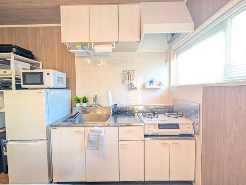 a kitchen with a refrigerator and a sink at 17minutes by car to Nagoya-Sta 1parking in Chiharachō