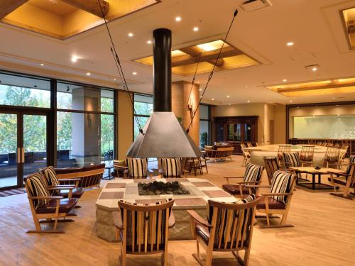 a large dining room with a table and chairs at Jozankei Manseikaku Hotel Milione in Jozankei