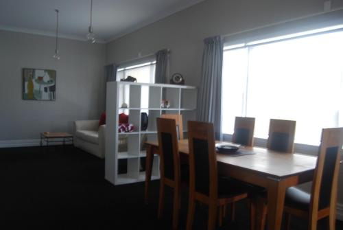 a dining room with a table and chairs and a couch at The Ohakune Central Motels in Ohakune