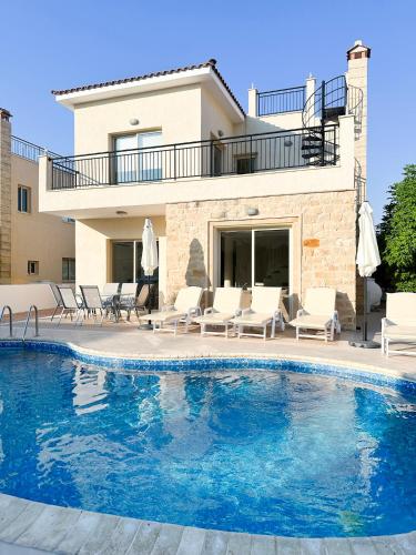 a swimming pool in front of a villa at Villa Merope Irena 1 in Polis Chrysochous