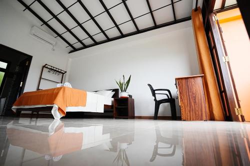 a bedroom with a bed in the middle of a room at Highclere Villa in Kamburugamuwa