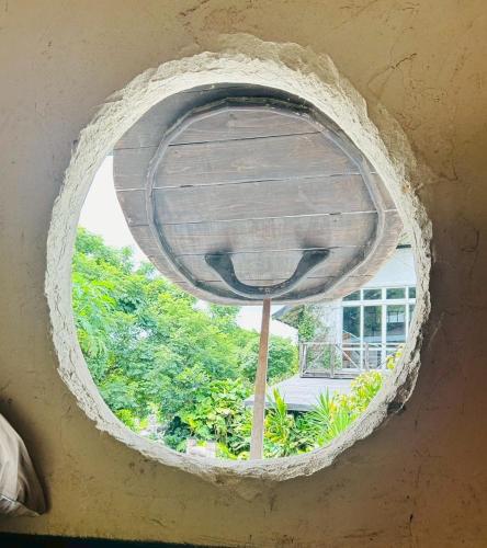 a round window in a building with a view at HiddenVilla in Nakijin