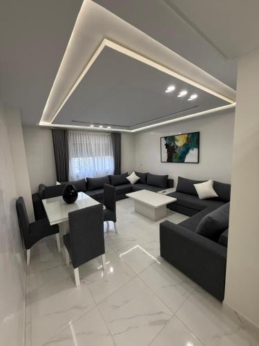 a living room with a couch and a table at Appart Résidence Sabrin in Fnidek