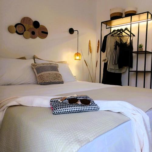 a bedroom with a bed with a bag on it at nisaki rooms & apartments in Methana