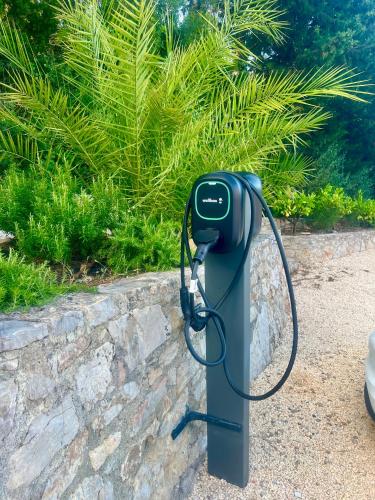 a pay phone is tied to a stone wall at La Casa dei Sogni in Flayosc