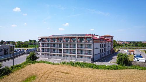 a large white building with a red roof at Hotel Borgo Brianteo in Ponte San Pietro