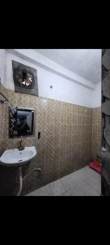 a bathroom with a sink and a mirror on the wall at Yash hotel in Lakhīmpur